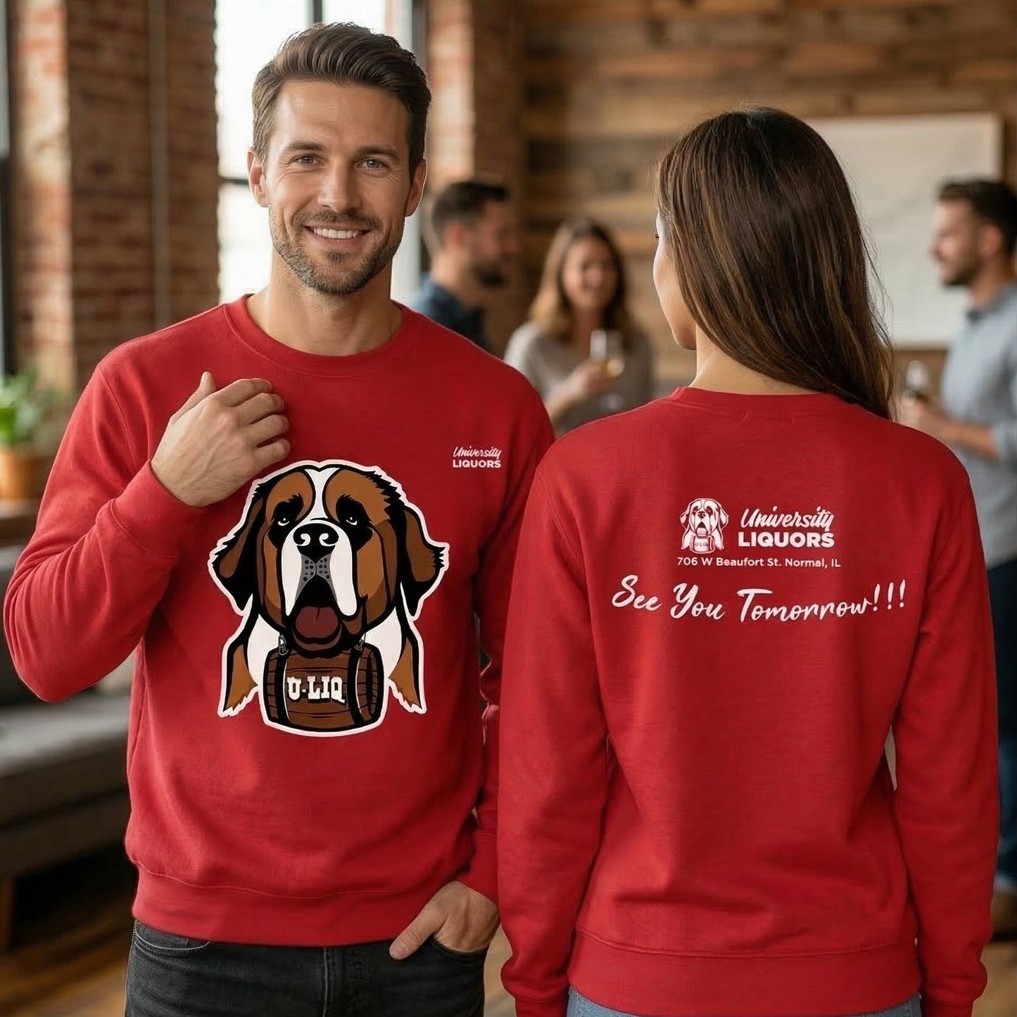 Two people wearing red University Liquors sweatshirts, standing in a casual indoor setting.