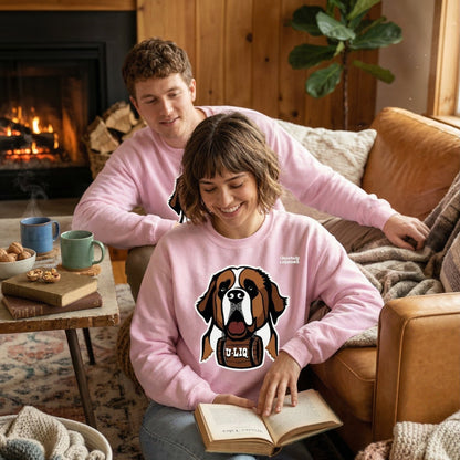 Two people wearing light pink University Liquors sweatshirt in a cozy living room.
