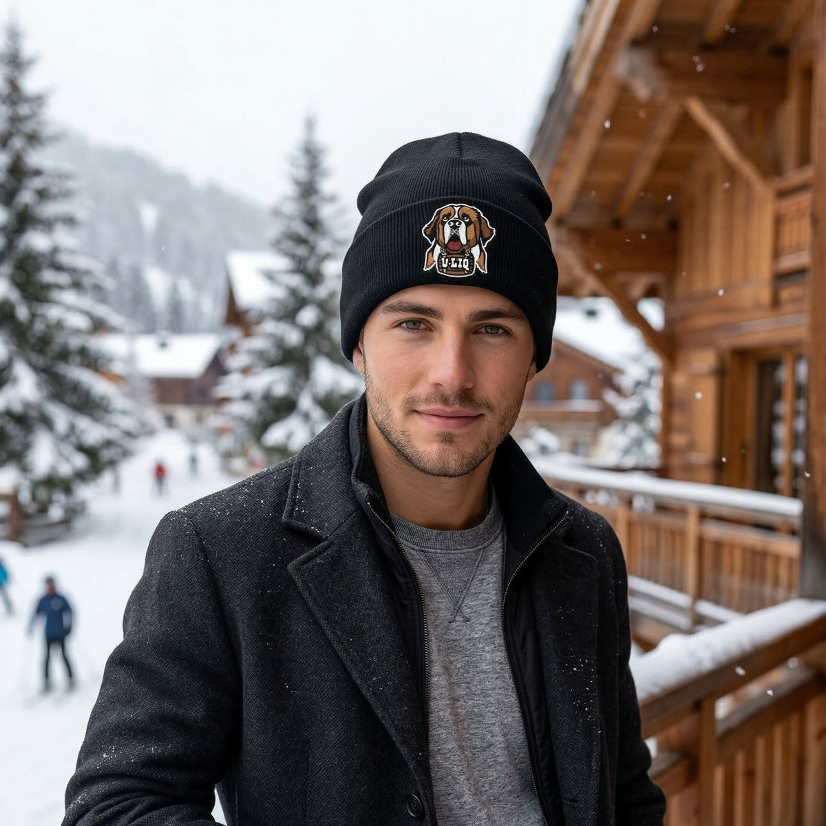 Man wearing a black beanie with a University Liquors logo in a snowy outdoor setting