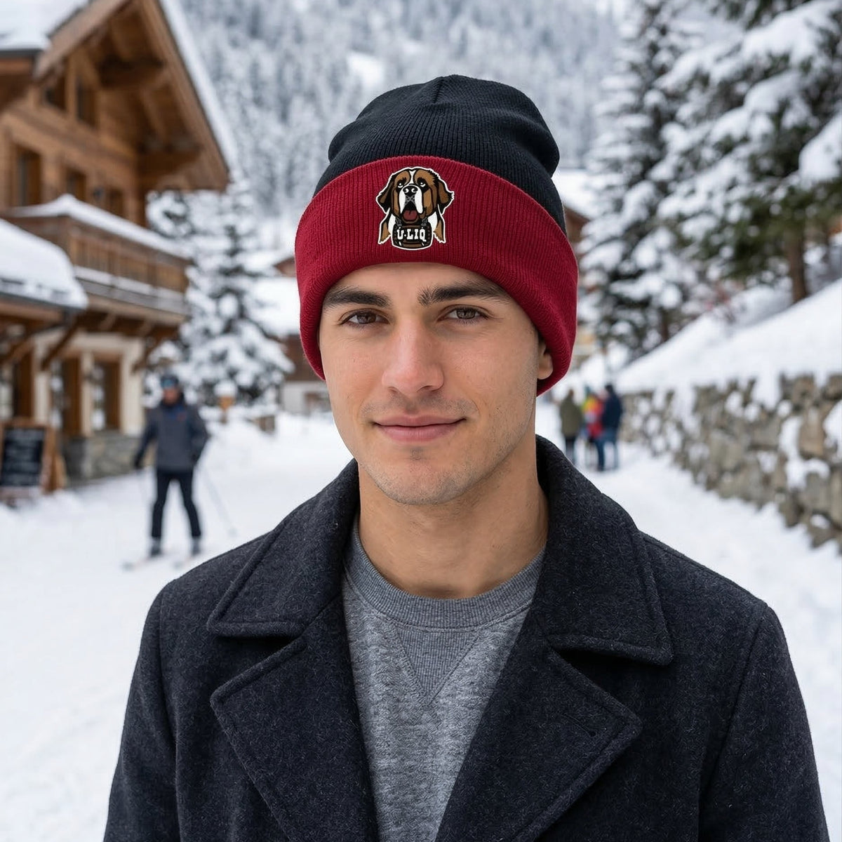 Man wearing a red and black beanie with a University Liquors logo in a snowy outdoor setting