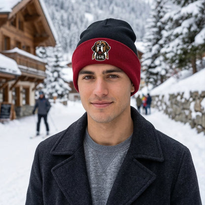 Man wearing a red and black beanie with a University Liquors logo in a snowy outdoor setting