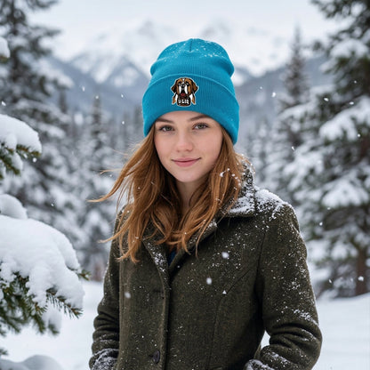Person wearing a blue beanie and coat in a snowy forest