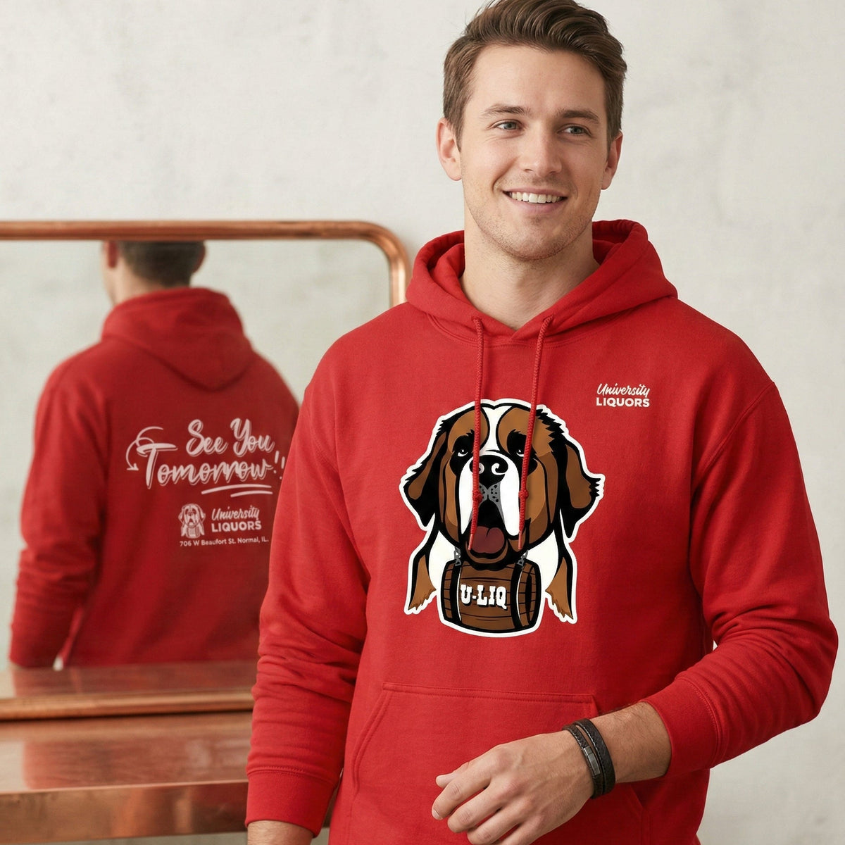 Man wearing a red University Liquors hoodie, standing in front of a mirror.