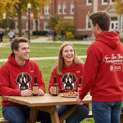 Three people in red University Liquors hoodie, sitting around a picnic table outdoors.