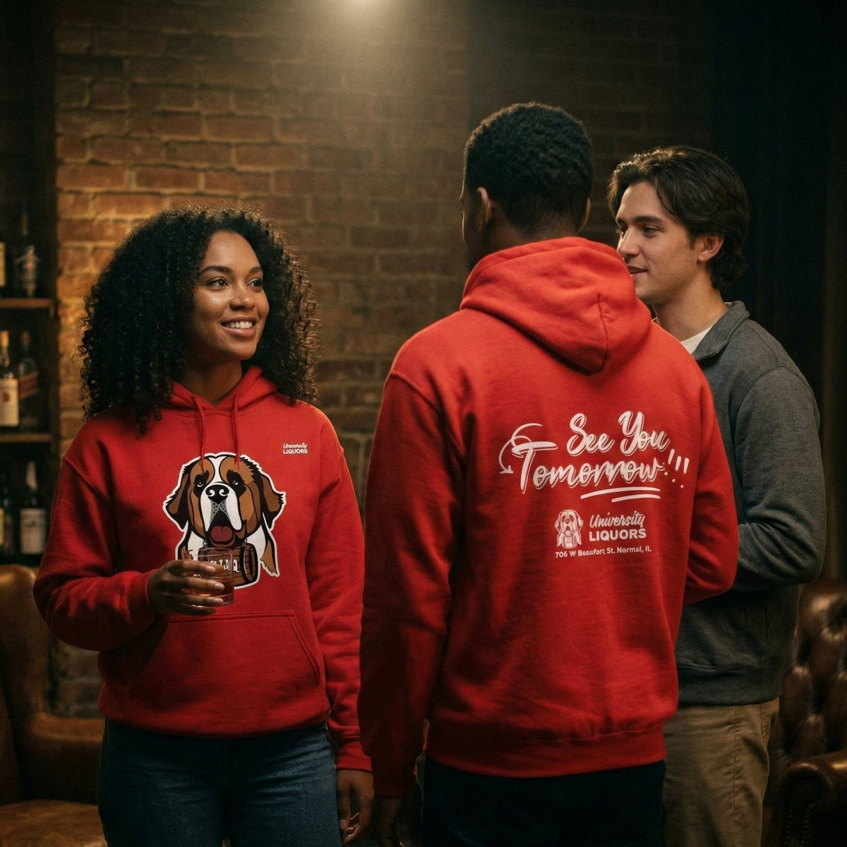 Two people wearing red University Liquors hoodie in a bar setting.